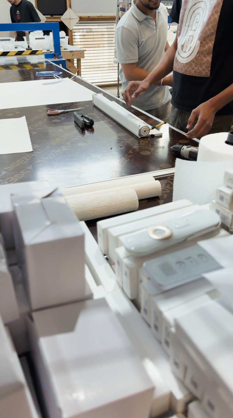 People preparing items on a table.