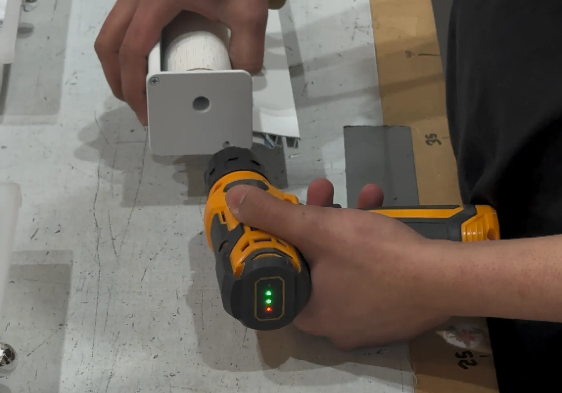 Person using a power tool on project