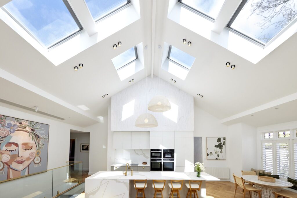 Modern kitchen with skylights and artwork